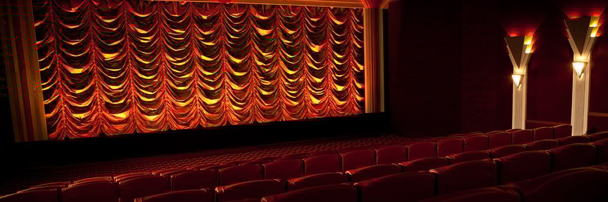 Stage-facing view of the The Roxy Cinema in Wellington with the red curtains closed over the stage